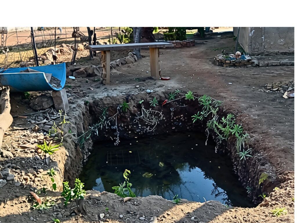 IN PHOTOS | No room left to dig: Inside Stinkwater’s pit toilet crisis 2 Open waterlogged hole in ground, once a pit toilet.